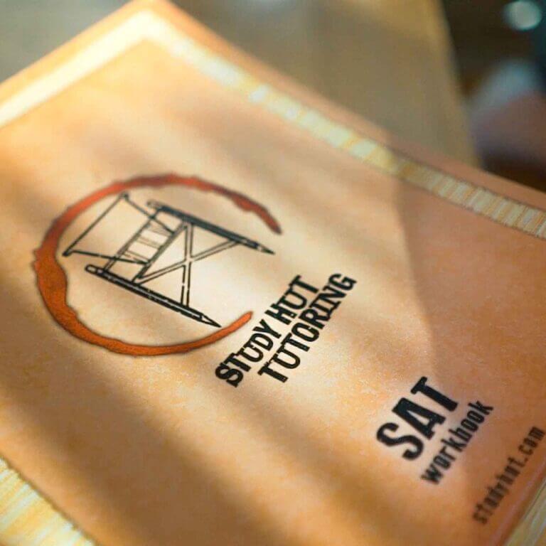 Close-up of a Study Hut Tutoring SAT workbook, emphasizing personalized test prep materials designed to help students boost their SAT scores with confidence.