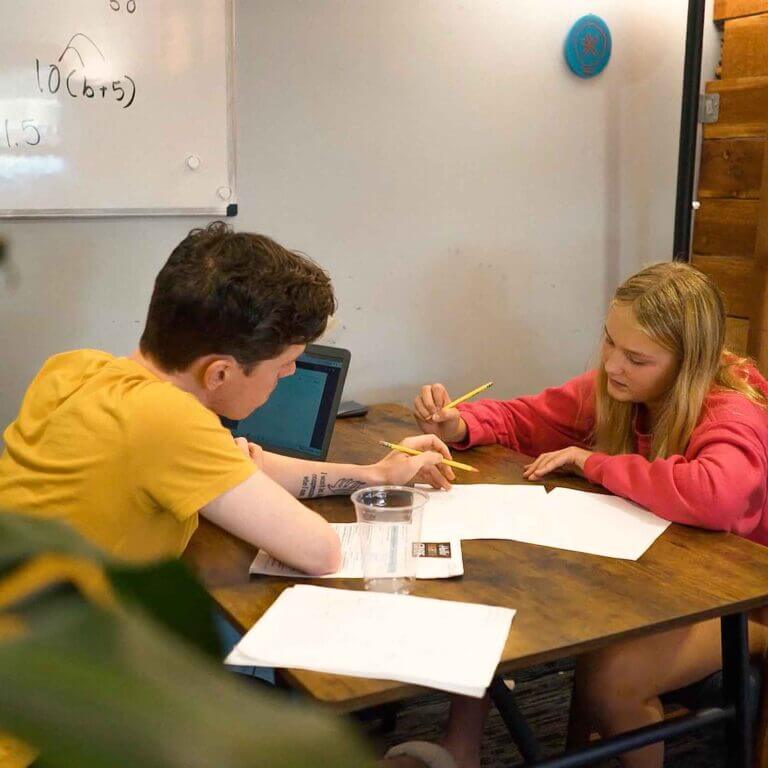 Focused one-on-one tutoring session at Study Hut, where a student and tutor work through math problems together in a supportive, distraction-free space.