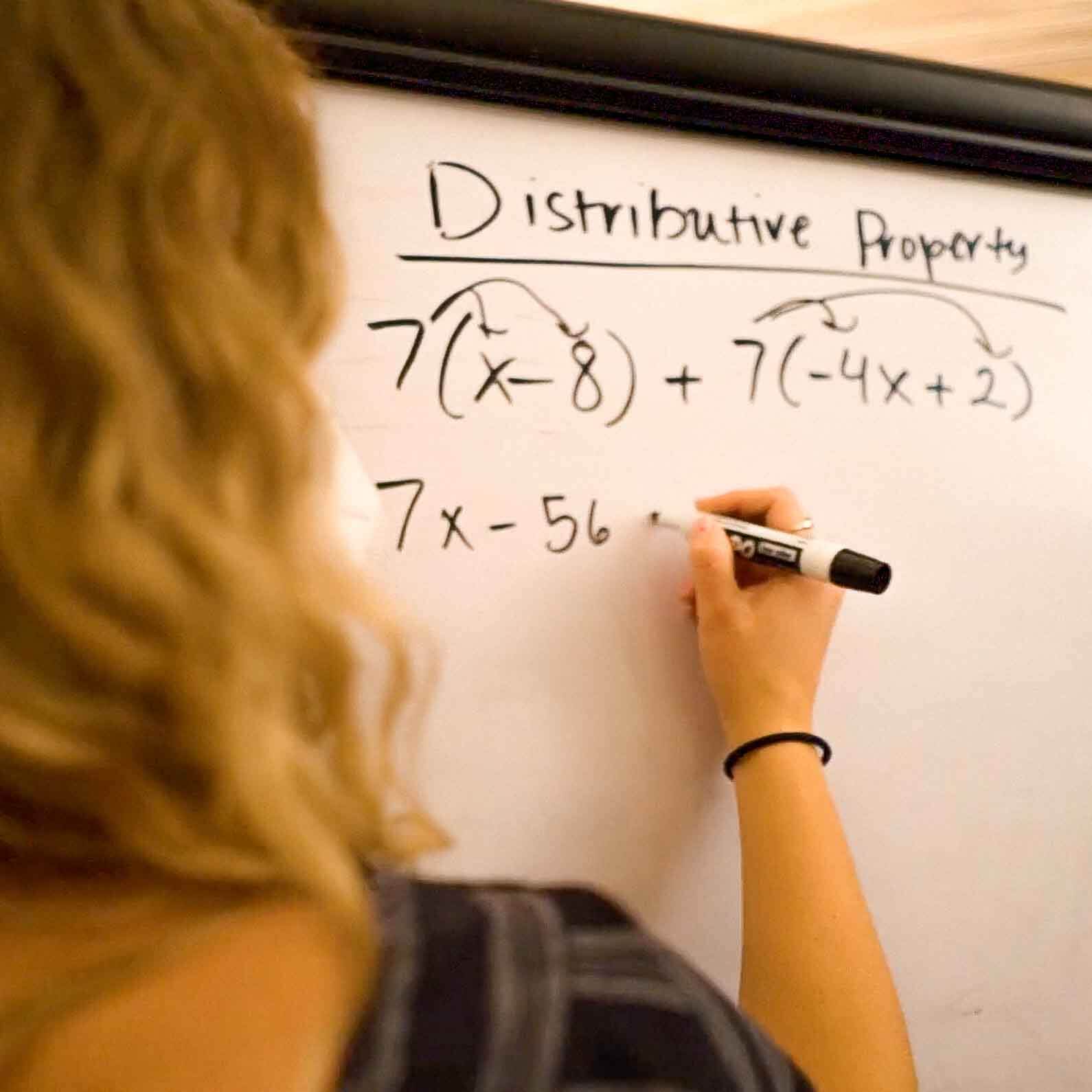 Tutor demonstrating the distributive property on a whiteboard during an ACT math prep session at Study Hut, focused on building confidence and test-taking skills.