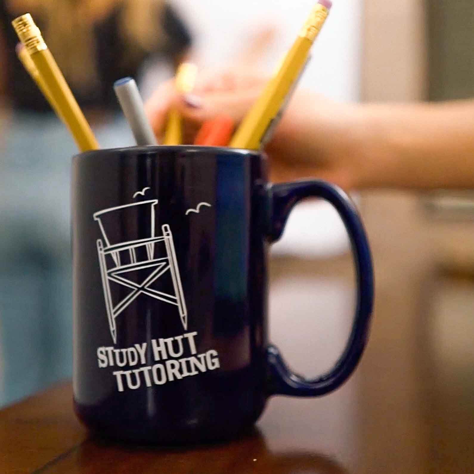 Close-up of a Study Hut Tutoring mug used as a pencil holder, capturing the laid-back, beachy vibe of the tutoring center’s creative learning space.